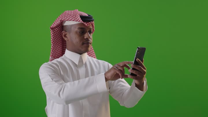 Saudi Man Using Smartphone on Green Screen