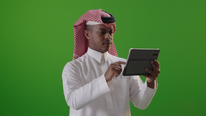 Saudi Man Using Tablet on Green Screen
