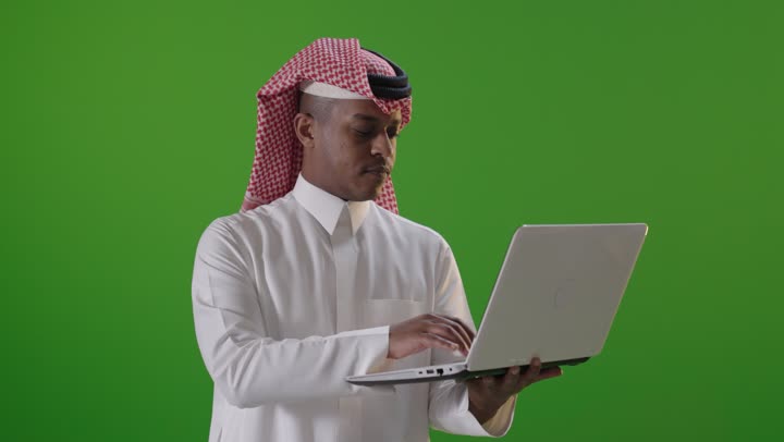Saudi Man Using Laptop on Green Screen