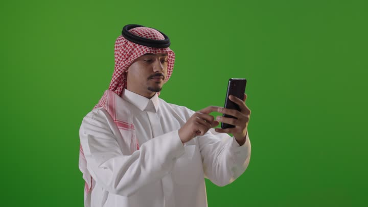 Saudi Man Using Smartphone on Green Screen