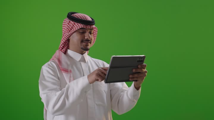 Saudi Man Using Digital Tablet on Green Screen