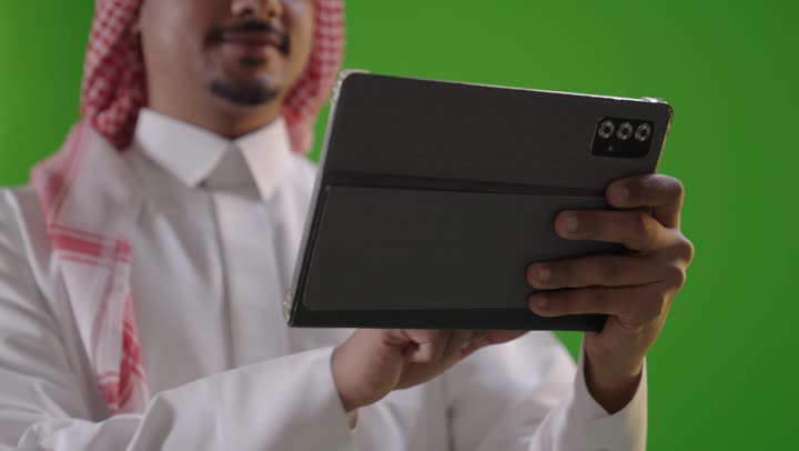Saudi Man Using Digital Tablet on Green Screen