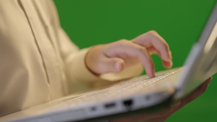 Saudi Man Typing on Laptop with Green Screen