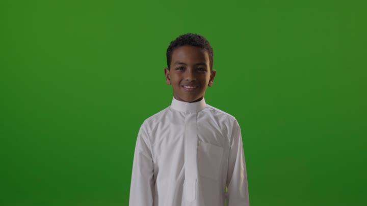 Saudi Boy in Thobe Giving Thumbs Up on Green Screen