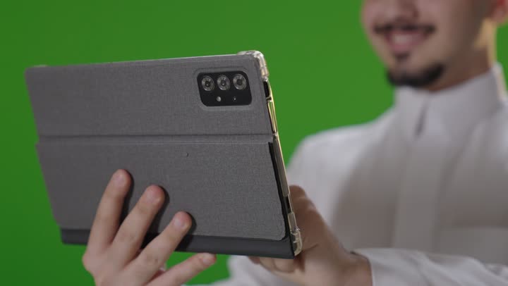 Saudi Man Using Tablet on Green Screen Background