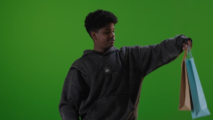 Saudi Boy Holding Shopping Bags on Green Screen