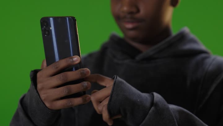 Saudi Boy Using Smartphone on Green Screen Footage