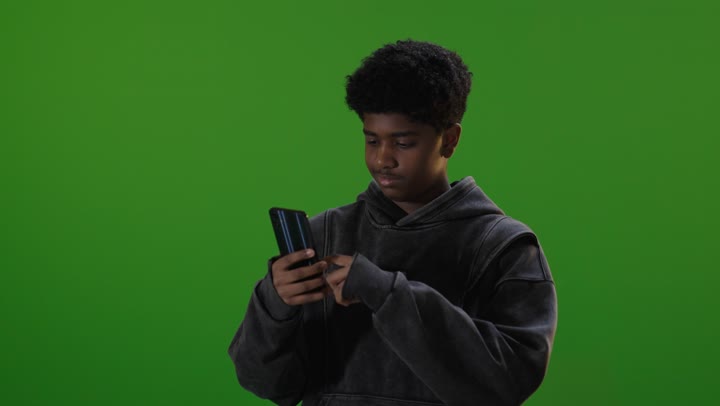Saudi Teenager Using Smartphone on Green Screen