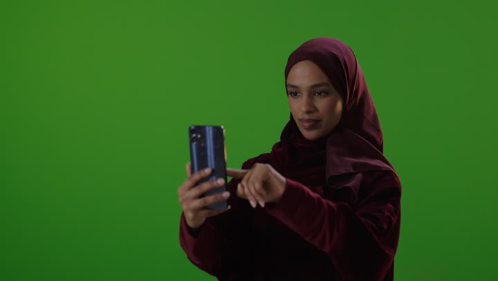 Saudi Woman Using Smartphone on Green Screen