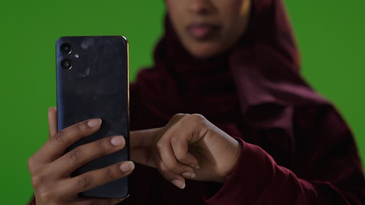 Saudi Woman Using Smartphone on Green Screen