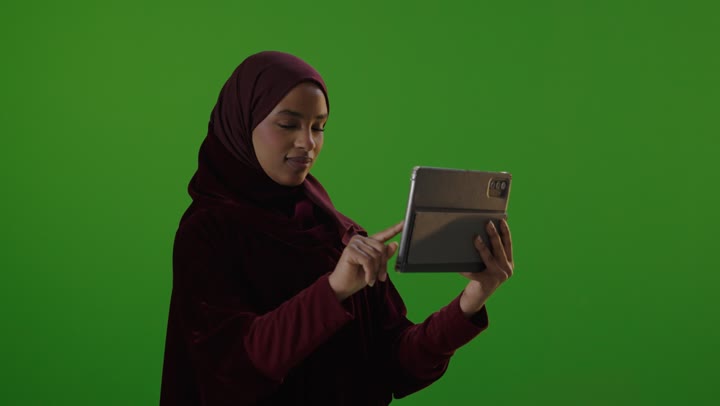 Saudi Woman Using Tablet on Green Screen Studio Footage