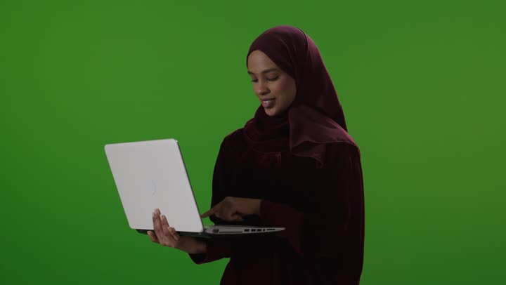 Saudi Woman Using Laptop on Green Screen Chroma Key