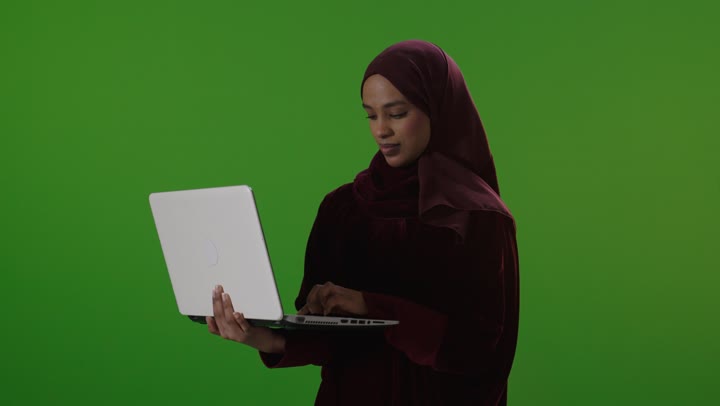 Saudi Woman Using Laptop on Green Screen Studio Footage
