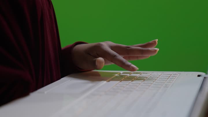 Saudi Woman Typing on Laptop Green Screen Close-up