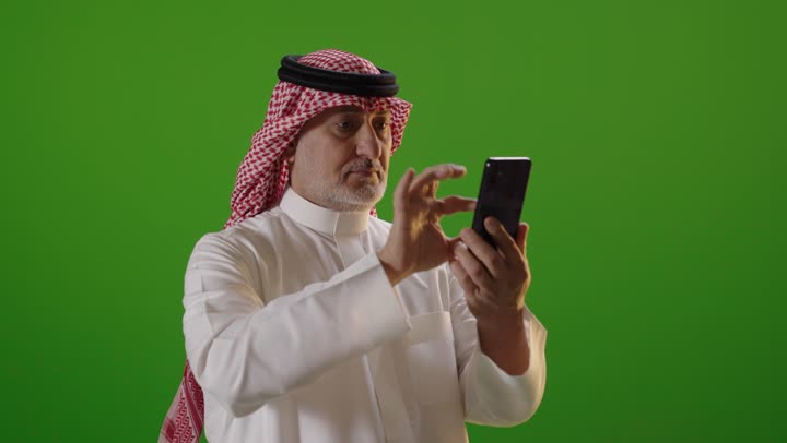 Saudi Man Using Smartphone on Green Screen