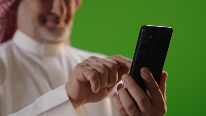 Saudi Man Using Smartphone on Green Screen