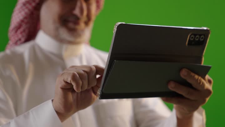 Saudi Man Using Digital Tablet on Green Screen