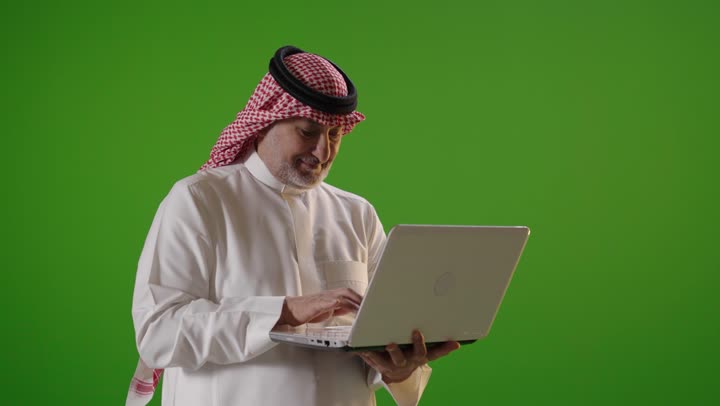 Saudi Man Using Laptop on Green Screen Studio Footage