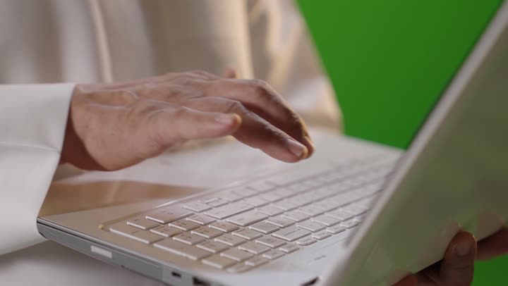 رجل سعودي يكتب على الكمبيوتر كروما شاشة خضراء