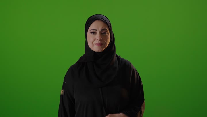 Saudi Woman in Abaya Smiling on Green Screen