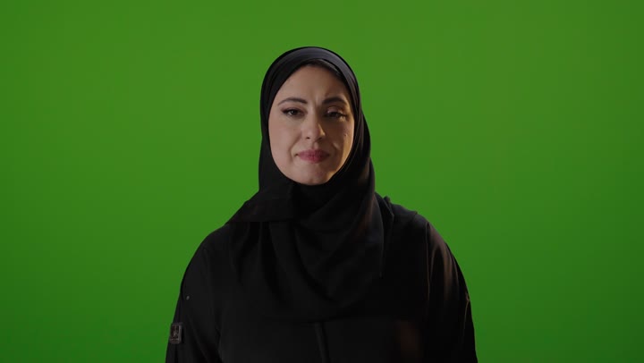 Saudi Woman in Abaya Smiling on Green Screen
