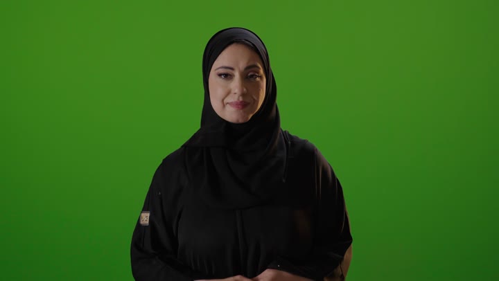 Saudi Woman in Abaya Smiling on Green Screen