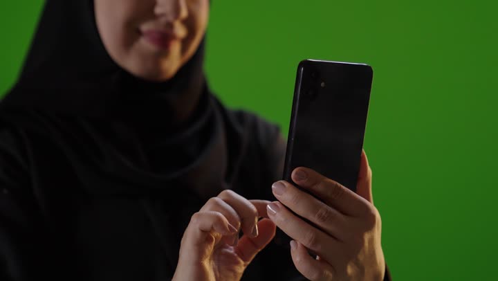 Saudi Woman Using Smartphone on Green Screen Footage