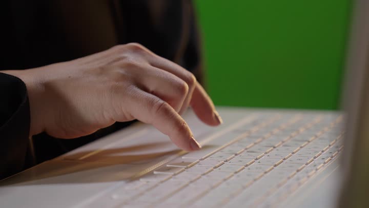 Saudi Woman Typing on Laptop with Green Screen Close Up