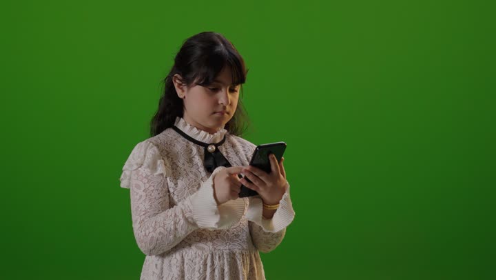 Saudi Girl Using Smartphone on Green Screen Background