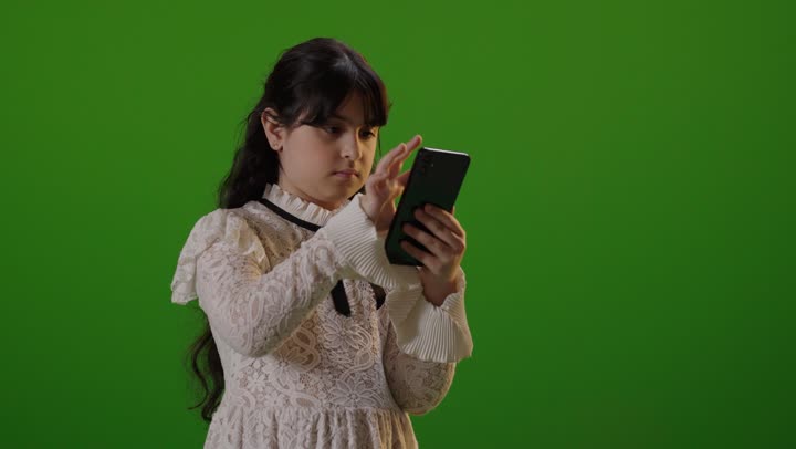 Saudi Girl Using Smartphone on Green Screen Background