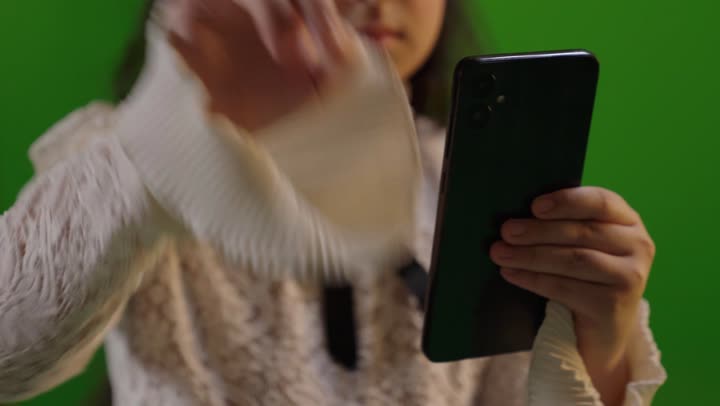 Saudi Girl Using Smartphone on Green Screen Background