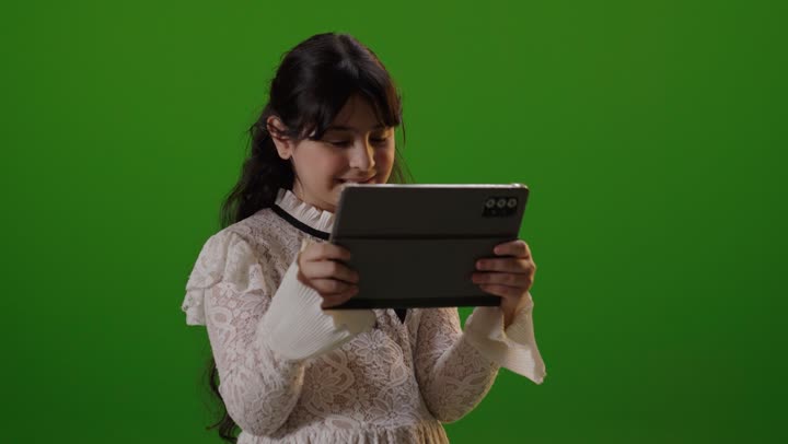 Saudi Girl Using Tablet on Green Screen Studio