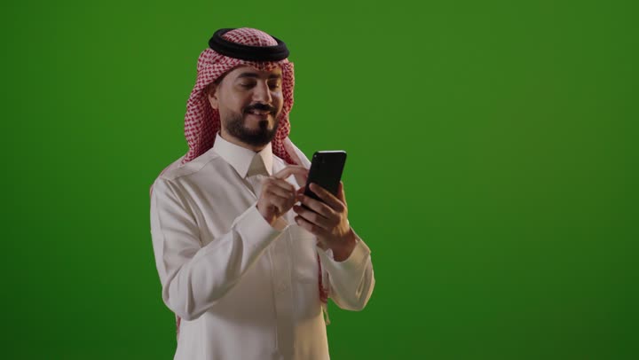 Saudi Man Using Smartphone on Green Screen