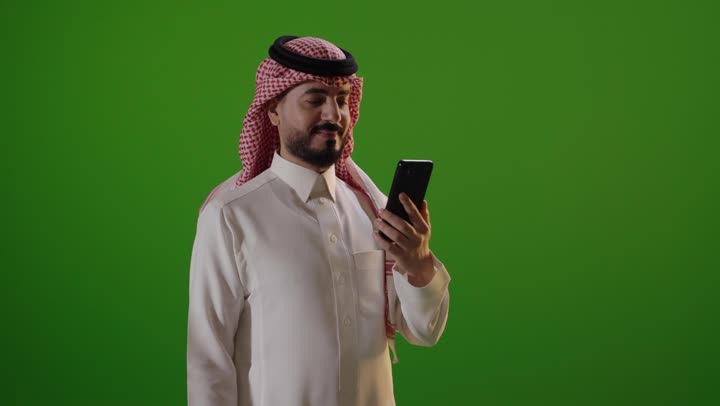Saudi Man Using Smartphone on Green Screen Footage