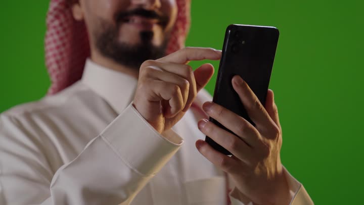 Saudi Man Using Smartphone Green Screen Studio Footage