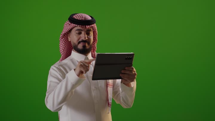 Saudi Man Using Digital Tablet on Green Screen