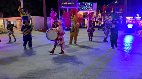 A performance by a musical band and theatrical performers at a night festival in Yanbu.