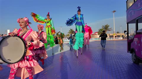 A performance show of colorful performers on wooden legs at a festival in the city of Yanbu.