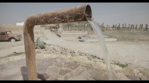 Water Flowing From Old Pipe in Desert Farm