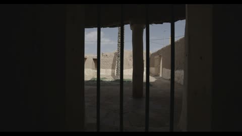 Traditional Mud House Courtyard View Through Iron Bars