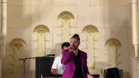 Male Singer in Purple Blazer Performing Live Stage