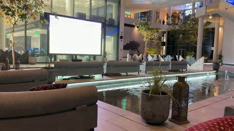 Outdoor Lounge and Projector Screen at Night
