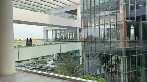 Women in Abayas Walking in Modern Saudi Building
