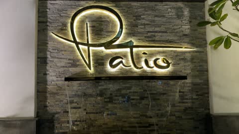 Patio Illuminated Sign on Stone Wall with Waterfall