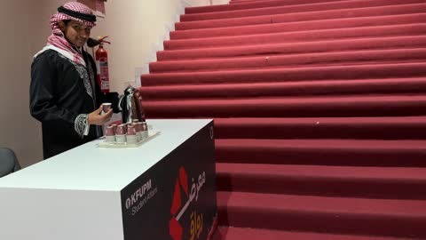 Saudi Man Pouring Coffee at KFUPM Event Booth