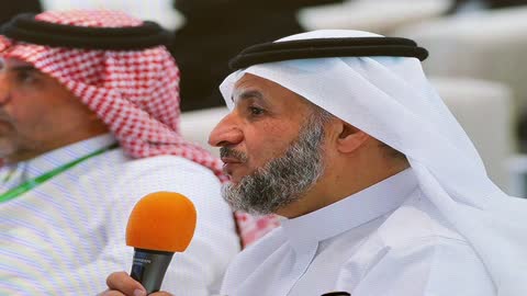 Saudi Man Speaking into Microphone at Conference Footage