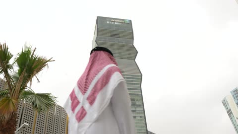 Saudi Man Looking at Aramco Building Riyadh KAFD