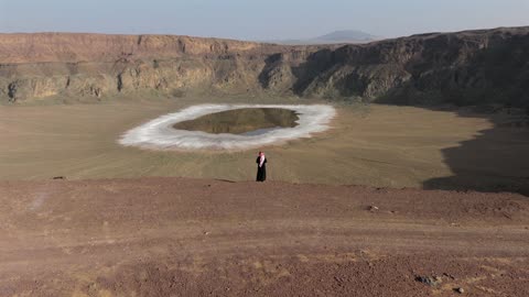 Man at Volcanic Crater Saudi Arabia Aerial Drone Footage