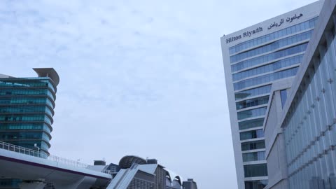 Riyadh Metro Train Moving Past Hilton Riyadh Hotel Footage