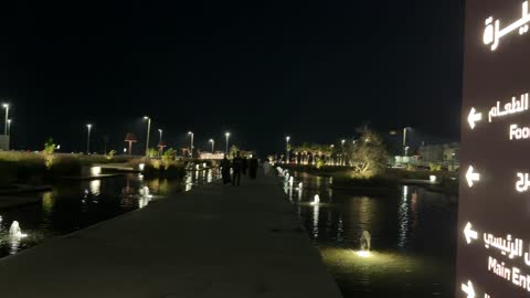 Arab Couple Walking At Al Buhaira Waterfront Night